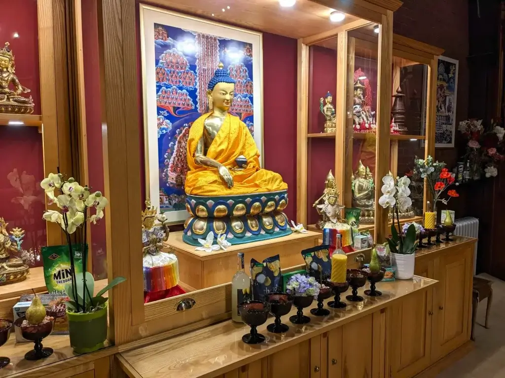 Buddhist shrine with statues and offerings at Vajrapani Kadampa Meditation Centre